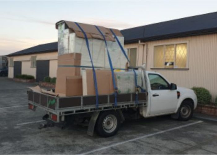 Ute in carpark with multiple switchboards on the tray for delivery