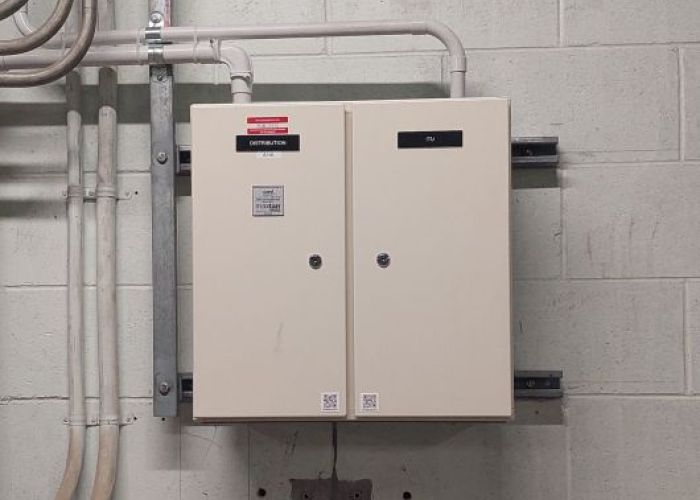 Two door small distribution board on white painted basement wall